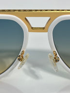Louis Vuitton sunglasses close-up, white frame with gold-tone bridge and hinges