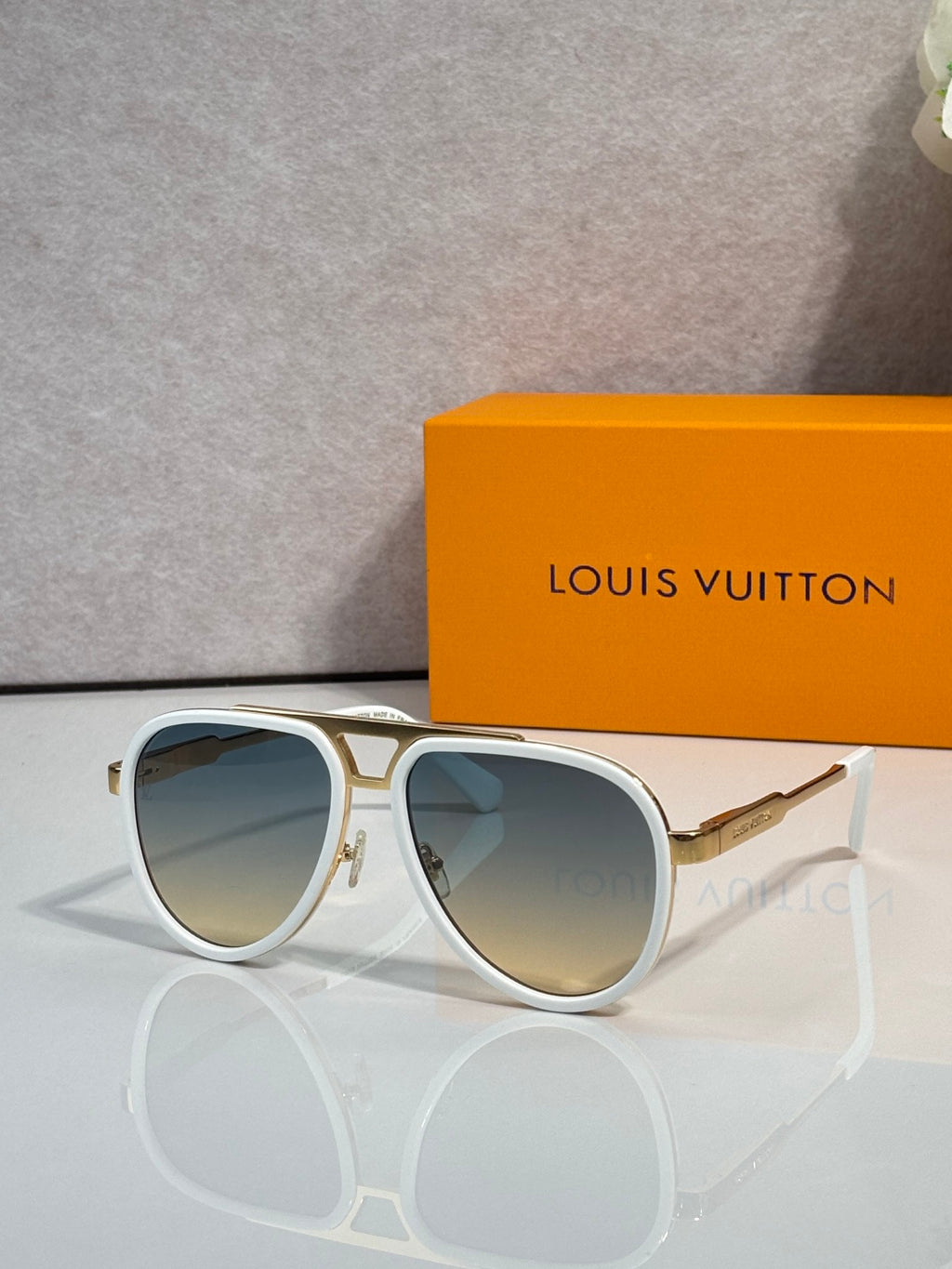 Louis Vuitton sunglasses with white frames and blue tinted lenses