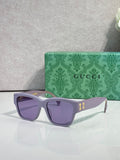 Gucci glasses with light gray frame and purple-tinted lenses, gold logo accents