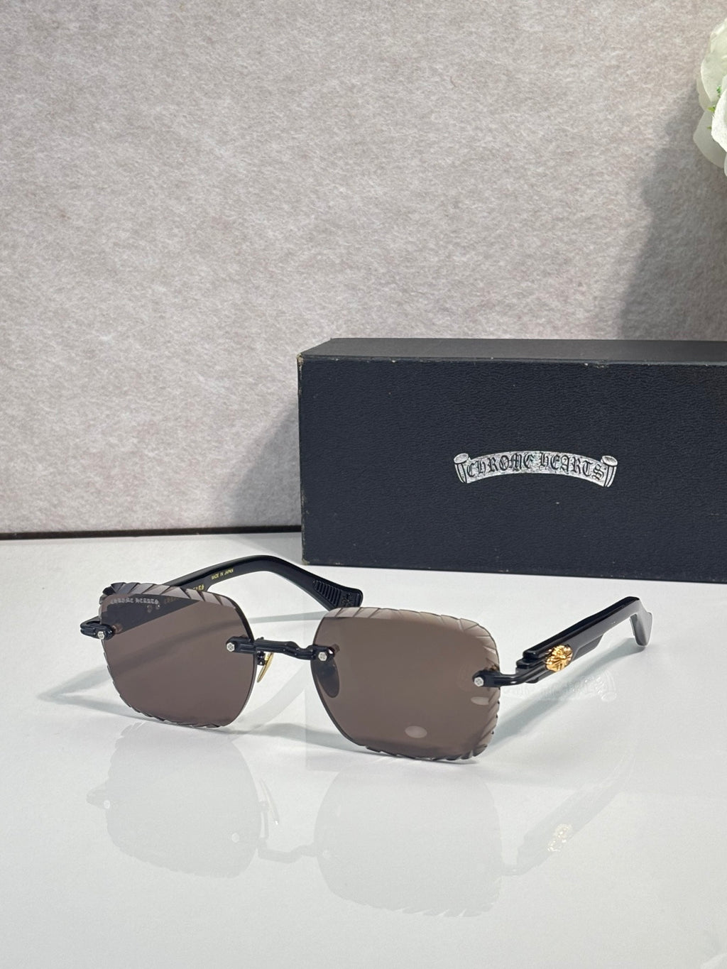 Chrome sunglasses with brown gradient lenses, dark frame, and metal temple accents