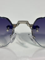 Chrome sunglasses front view with dark tinted lenses, blue temple arms, and metal hinges