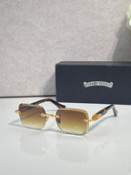 Chrome sunglasses with amber gradient lenses, gold-tone frame, and metal temple detailing