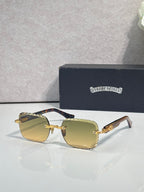 Chrome sunglasses with yellow-gold gradient lenses, gold-tone frame, and patterned temples