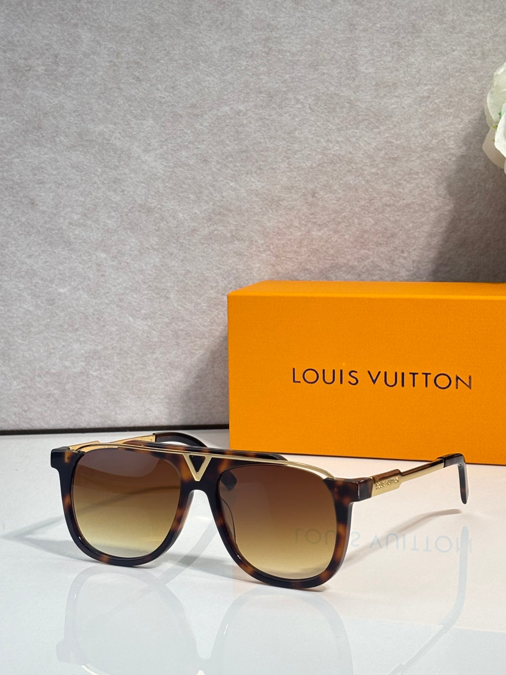 Louis Vuitton square sunglasses with warm brown lenses and tortoiseshell frame