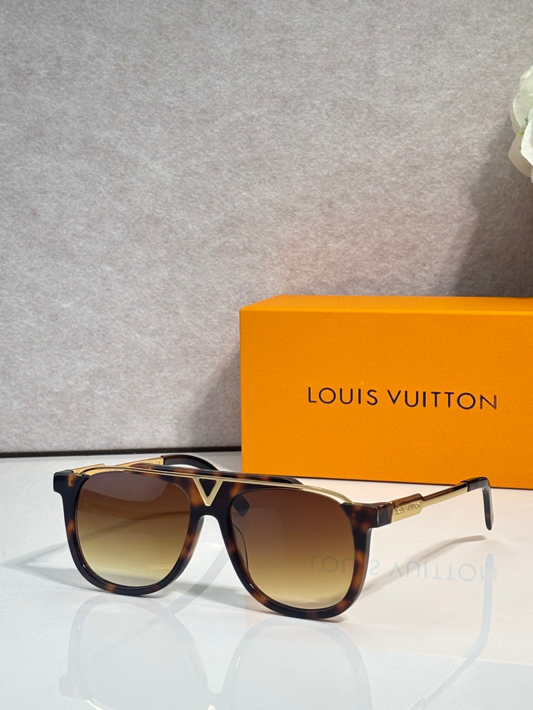 Louis Vuitton square sunglasses with warm brown lenses and tortoiseshell frame