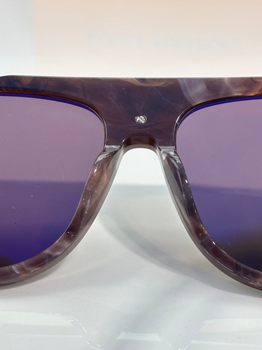 Louis Vuitton close-up of purple-tinted sunglasses lens and tortoiseshell frame