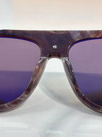 Louis Vuitton close-up of purple-tinted sunglasses lens and tortoiseshell frame