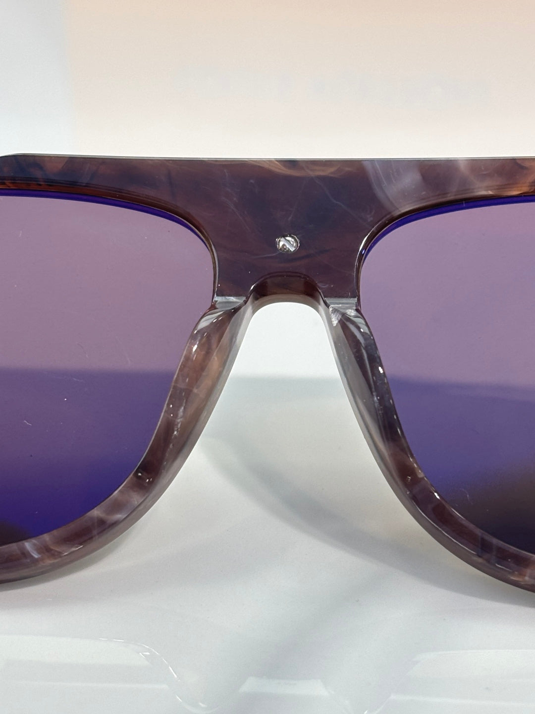 Louis Vuitton close-up of purple-tinted sunglasses lens and tortoiseshell frame