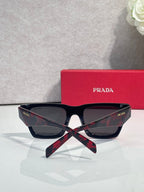 Prada glasses with dark frame and dark lenses, with red case