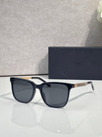 Sunglasses with navy frame and dark lenses, white temples.