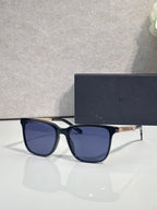 Sunglasses with deep blue frame and blue tinted lenses.
