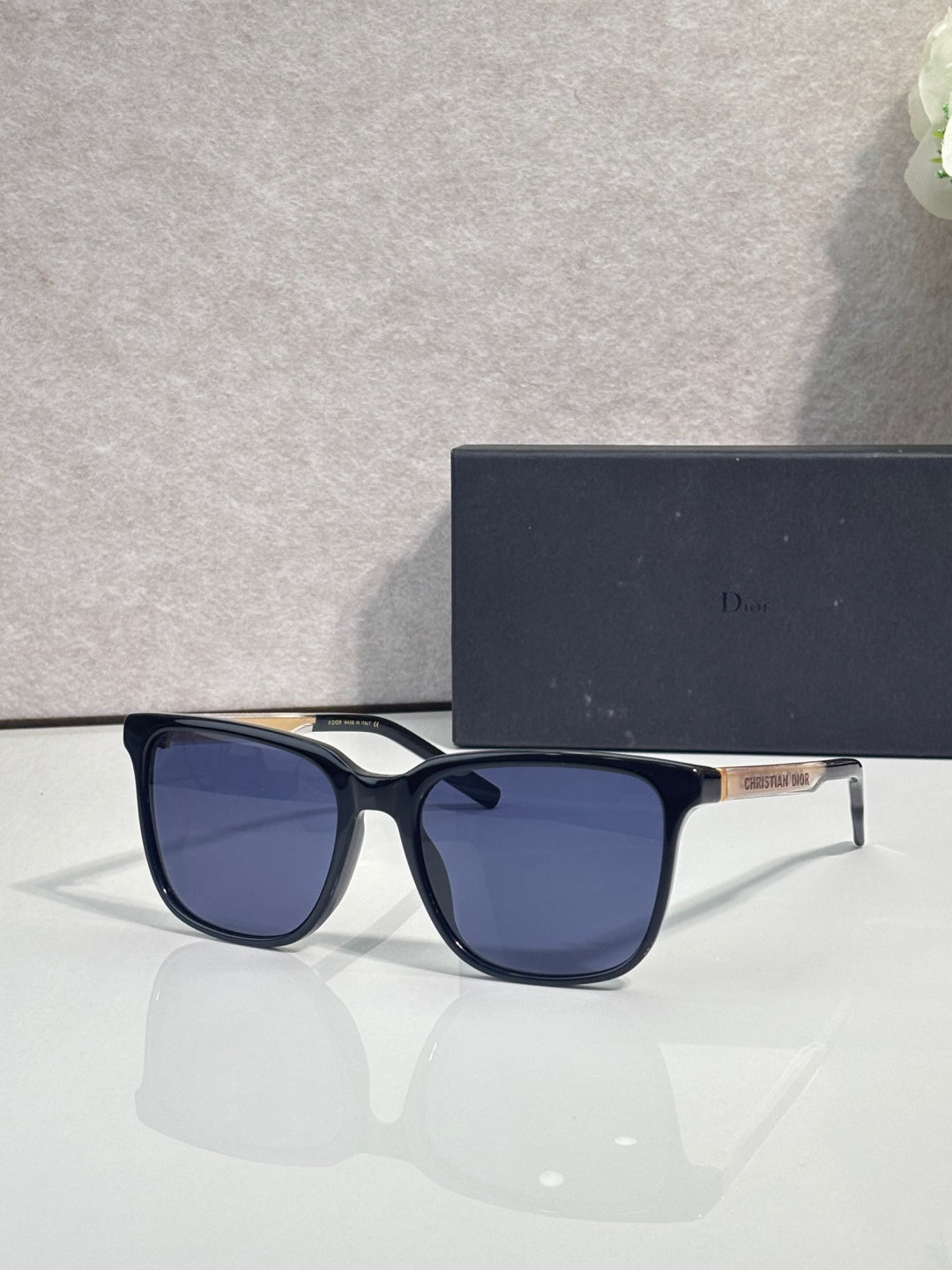 Sunglasses with deep blue frame and blue tinted lenses.