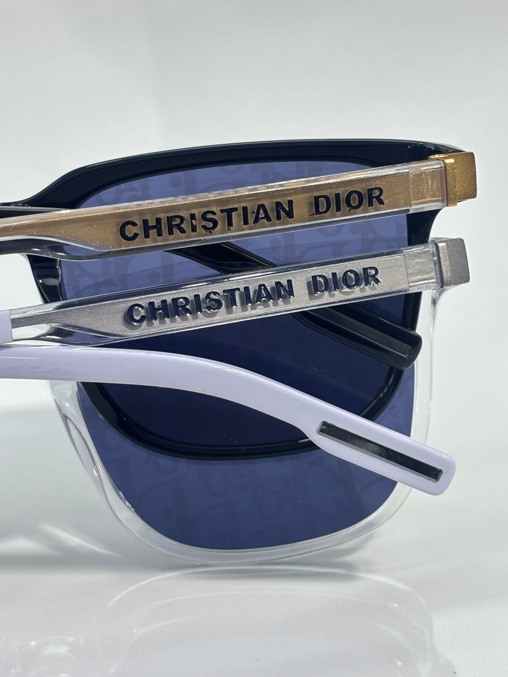 Sunglasses temples with Christian Dior logo and blue lenses.
