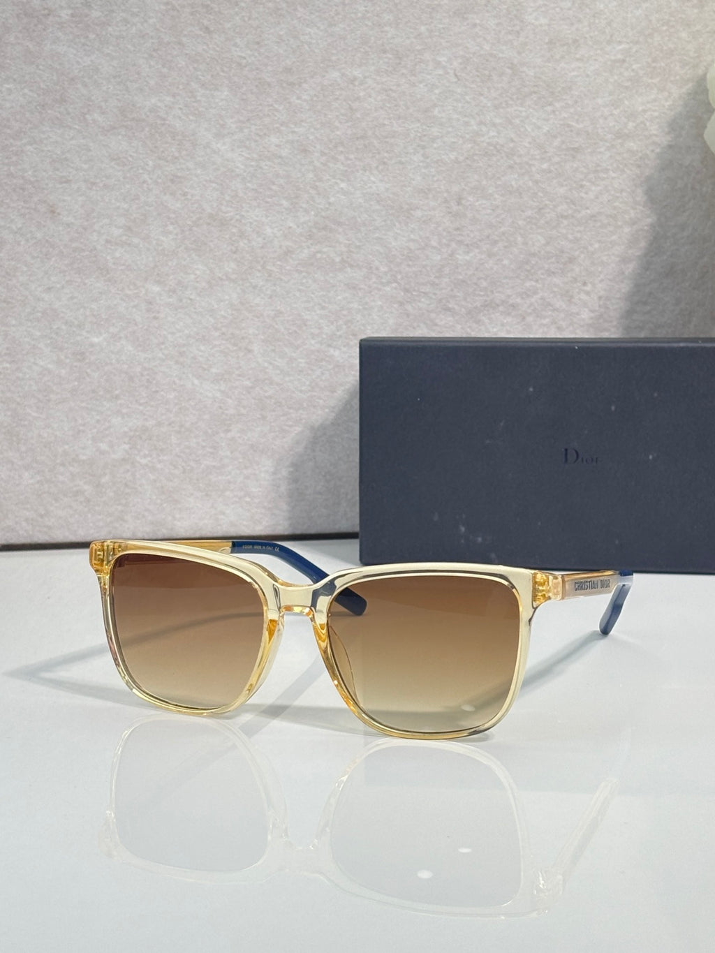 Sunglasses with gold frame and amber tinted lenses.