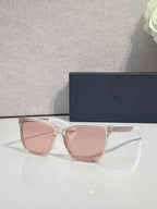 Sunglasses with clear pink frame and pink tinted lenses.