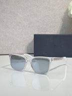 Dior glasses with light gray frames and blue gradient lenses