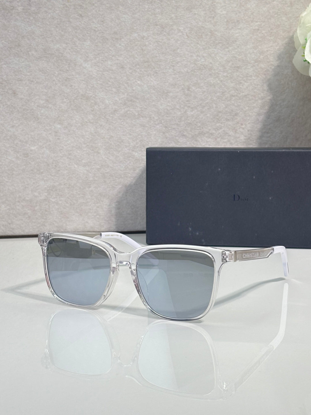 Dior glasses with light gray frames and blue gradient lenses