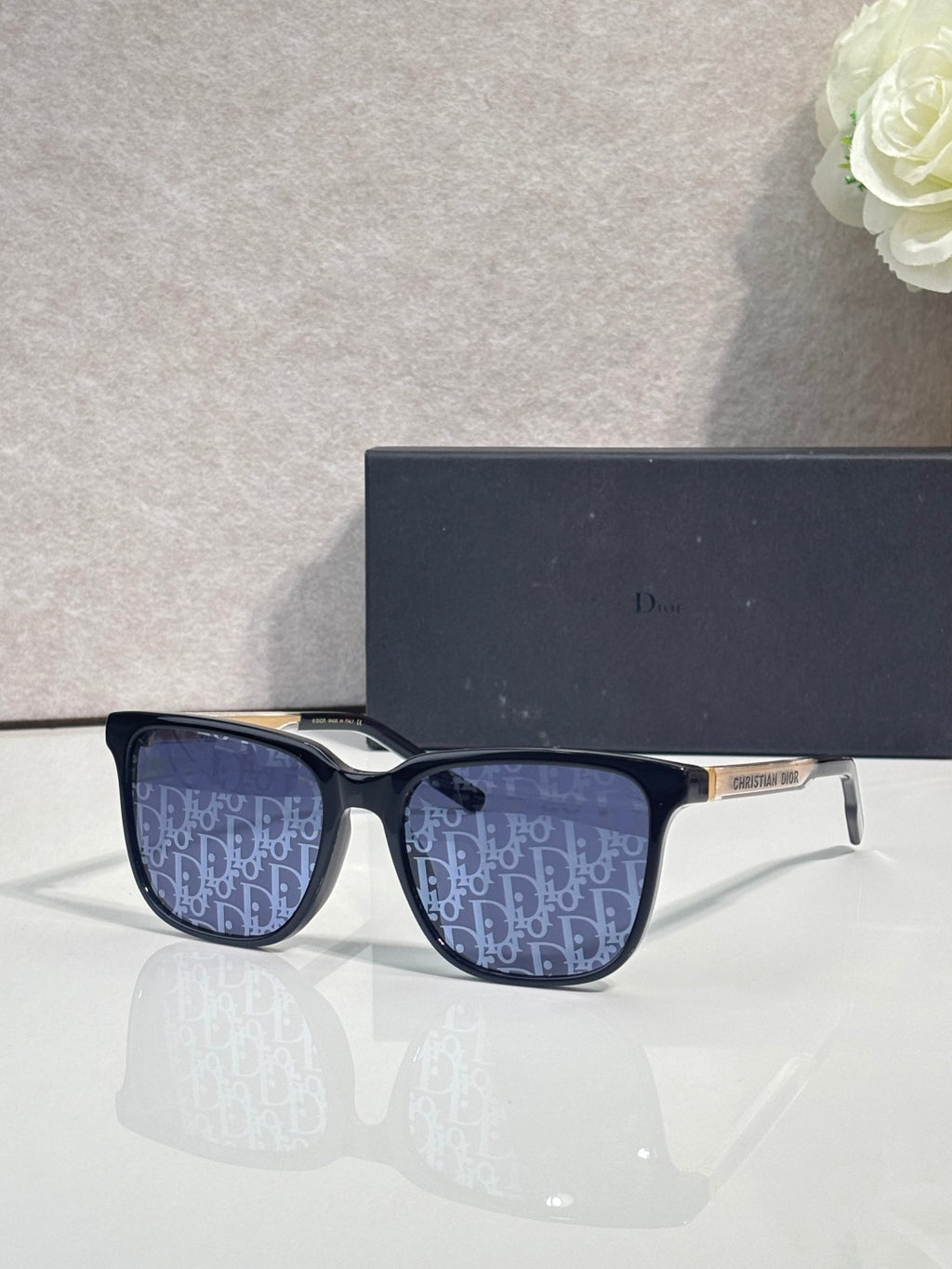 Dior glasses with dark blue frames and navy monogram-pattern lenses