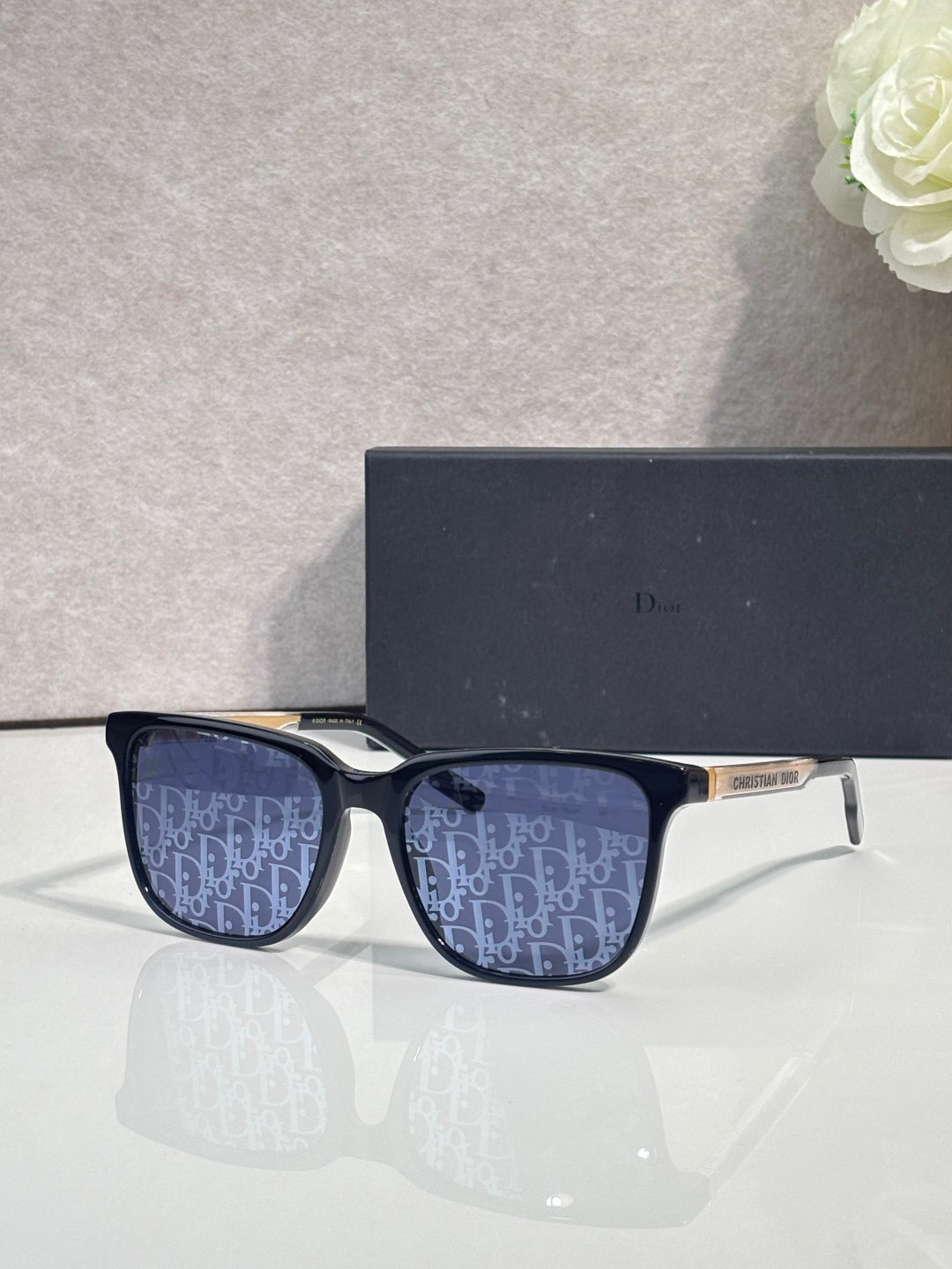 Dior glasses with dark blue frames and navy monogram-pattern lenses