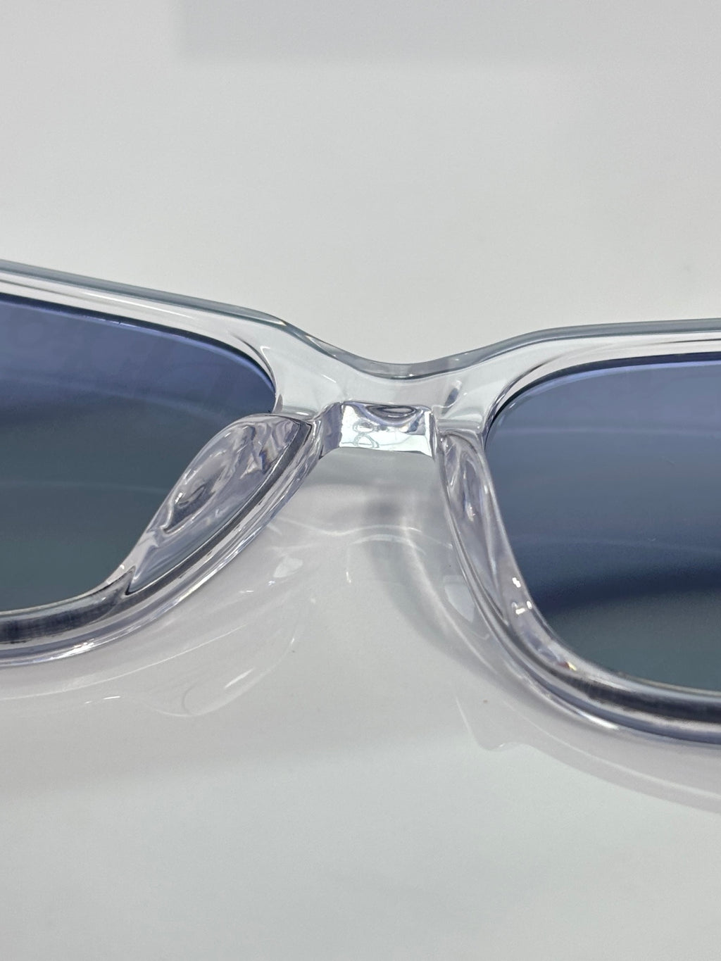 Dior glasses close-up of clear front frame and blue tinted lenses