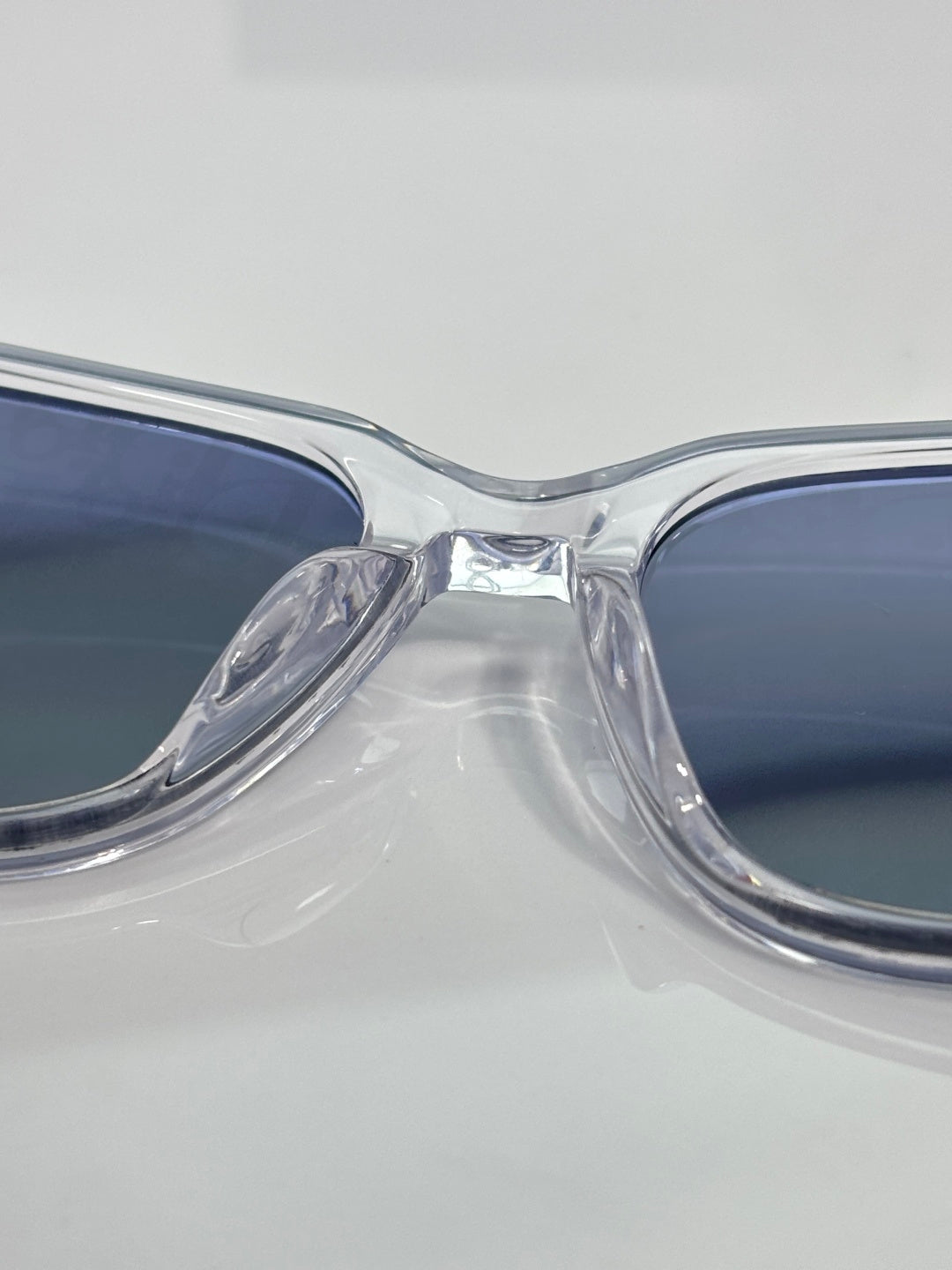Dior glasses close-up of clear front frame and blue tinted lenses