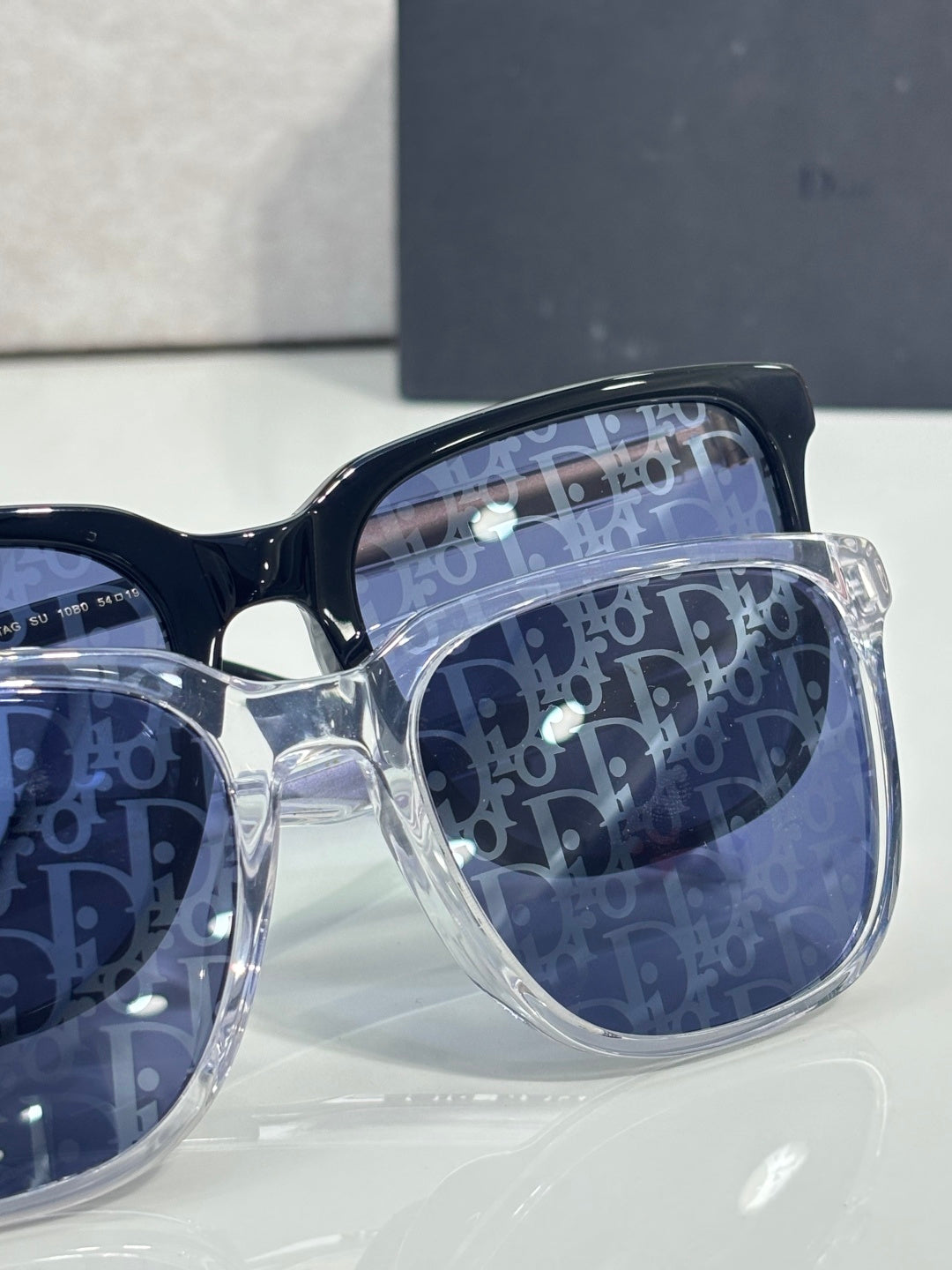 Dior glasses close-up of dark blue frames with blue monogram-pattern lenses