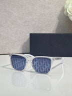 Dior glasses with white frames and blue monogram-pattern lenses