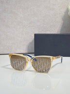 Dior glasses with gold frames and brown monogram-pattern lenses