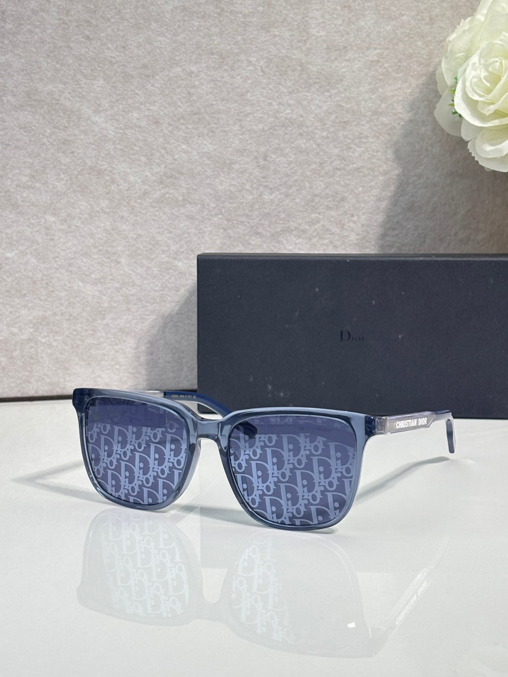 Dior glasses with blue monogram-pattern lenses and dark frame front