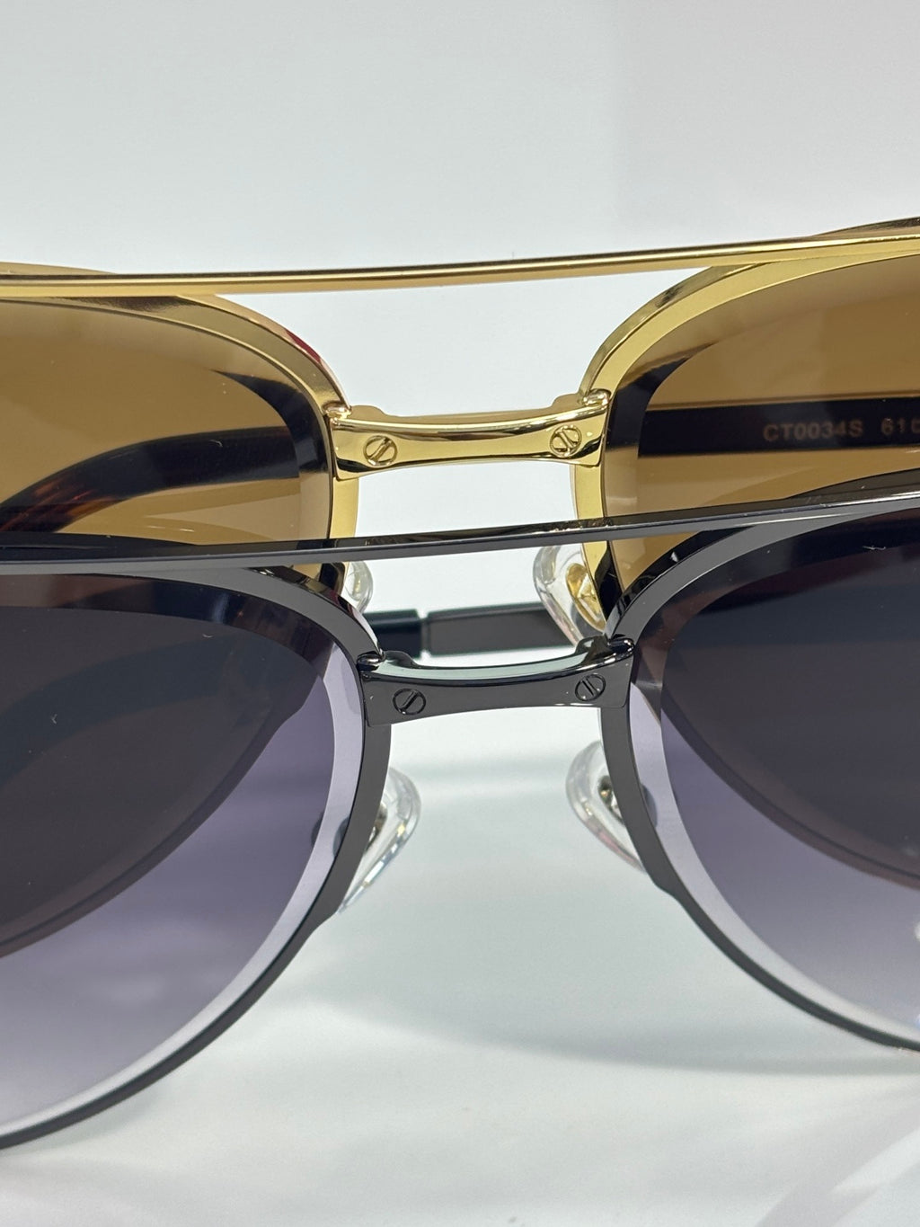 Sunglasses close-up with gold round frames and dark tinted lenses