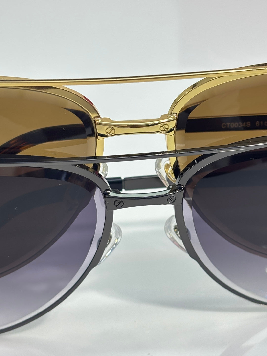 Sunglasses close-up with gold round frames and dark tinted lenses