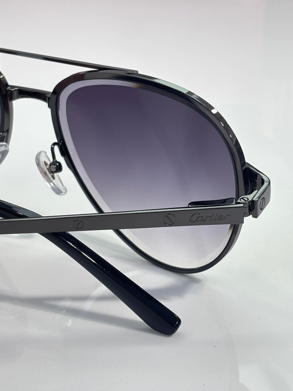 Sunglasses side view with dark frame and dark purple tinted gradient lenses