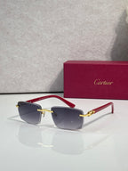 Gold sunglasses with dark gray lenses and red temple accents