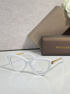 White cat-eye eyeglasses with clear lenses and gold-tone temple accents.