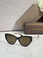Tortoise cat-eye sunglasses with dark tinted lenses and gold-tone temple accents.