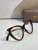 Tortoise cat-eye eyeglasses with clear lenses and decorative gold-tone detail.