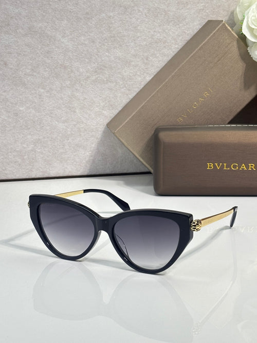 Black cat-eye sunglasses with dark tinted lenses and gold-tone temple accents.