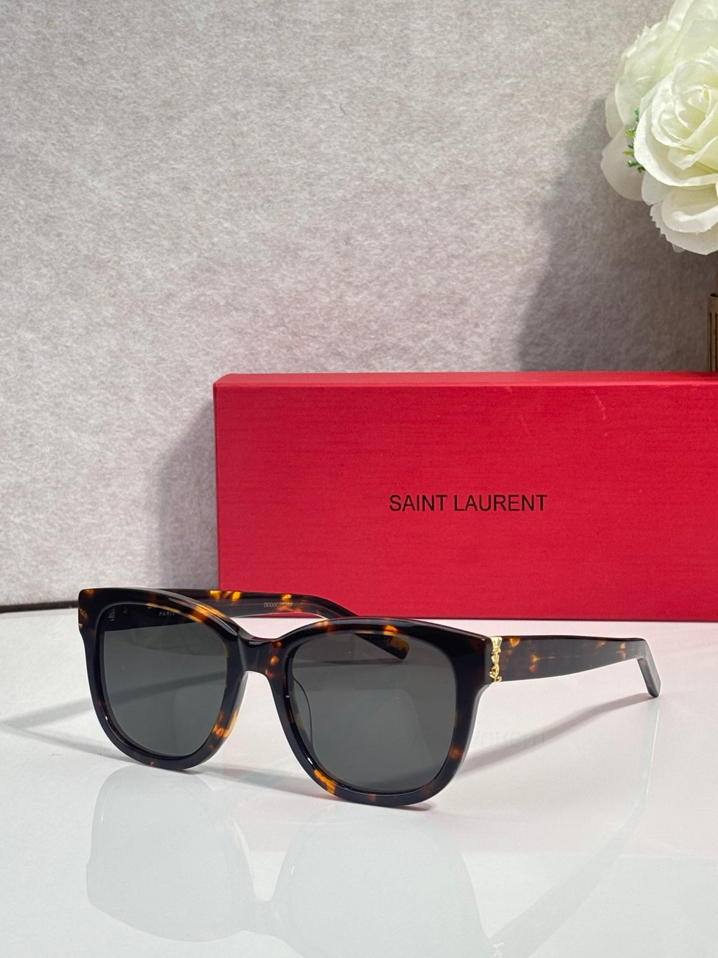 Saint Laurent eyeglasses with tortoise frame and dark lenses, side view
