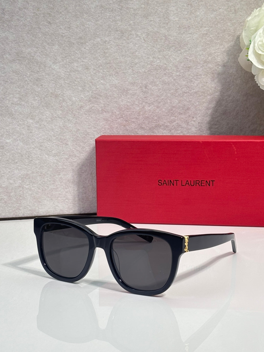 Saint Laurent eyeglasses with dark lenses and black frame, gold logo detail on arm