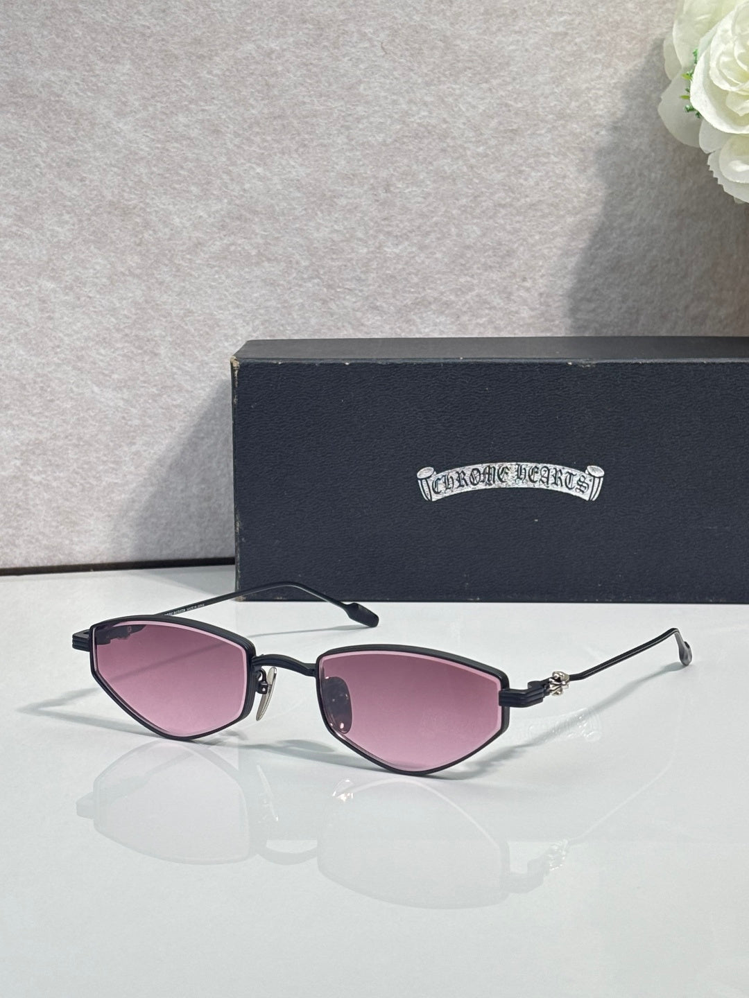 Gold-tone metal glasses with purple-tinted lenses and dark temple tips