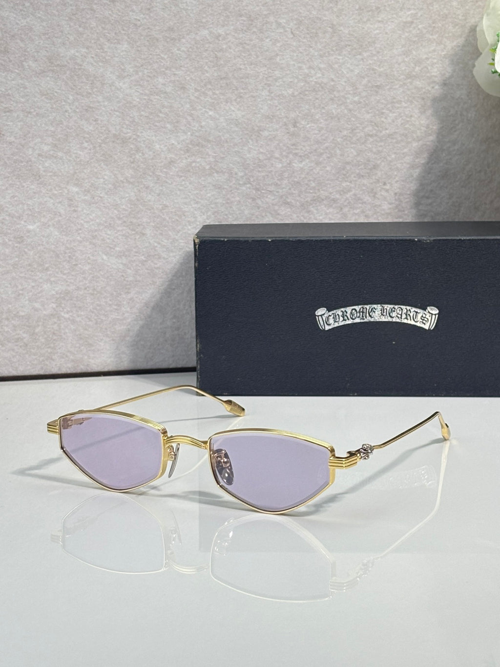 Gold-tone metal glasses with lavender lenses and gold metal frames