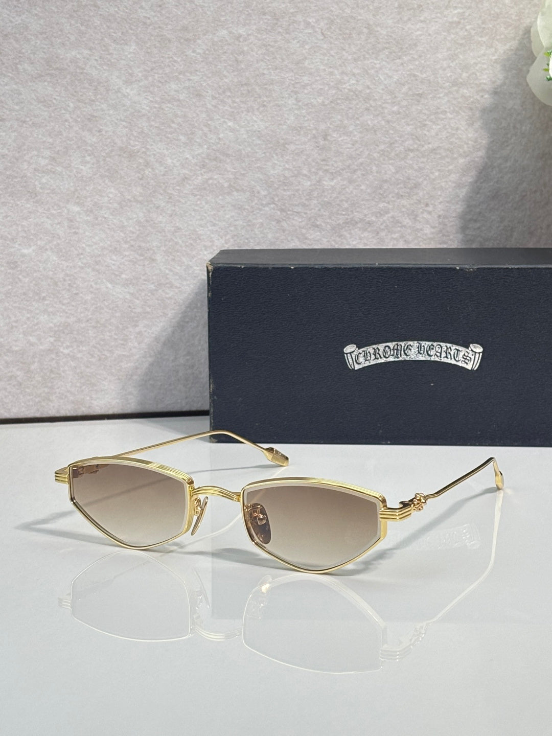 Gold-tone metal glasses with light beige lenses and narrow rims