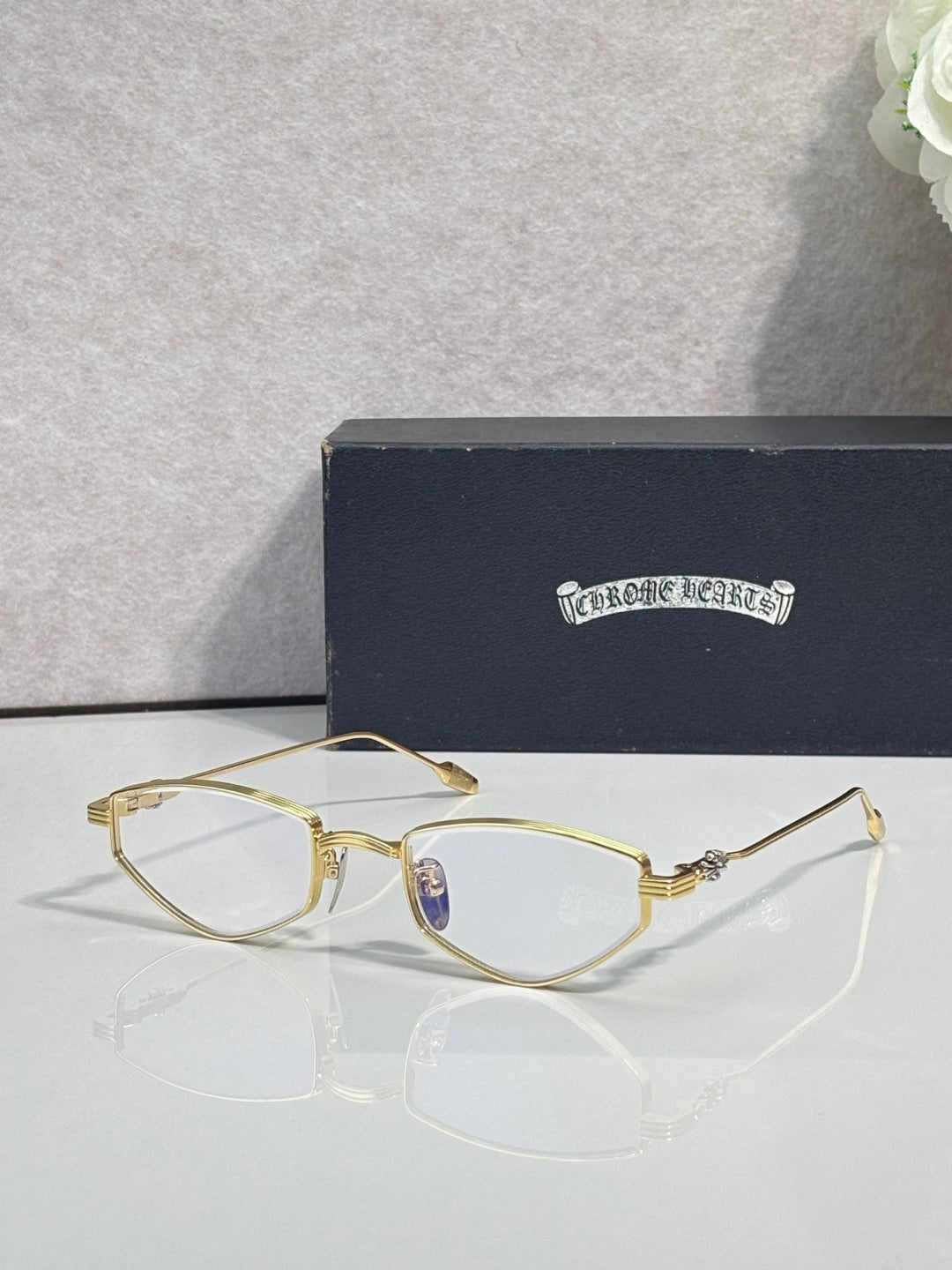 Gold-tone metal glasses with clear lenses and thin curved rims
