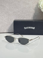 Gold-tone metal glasses with dark tinted lenses and curved clear bridge