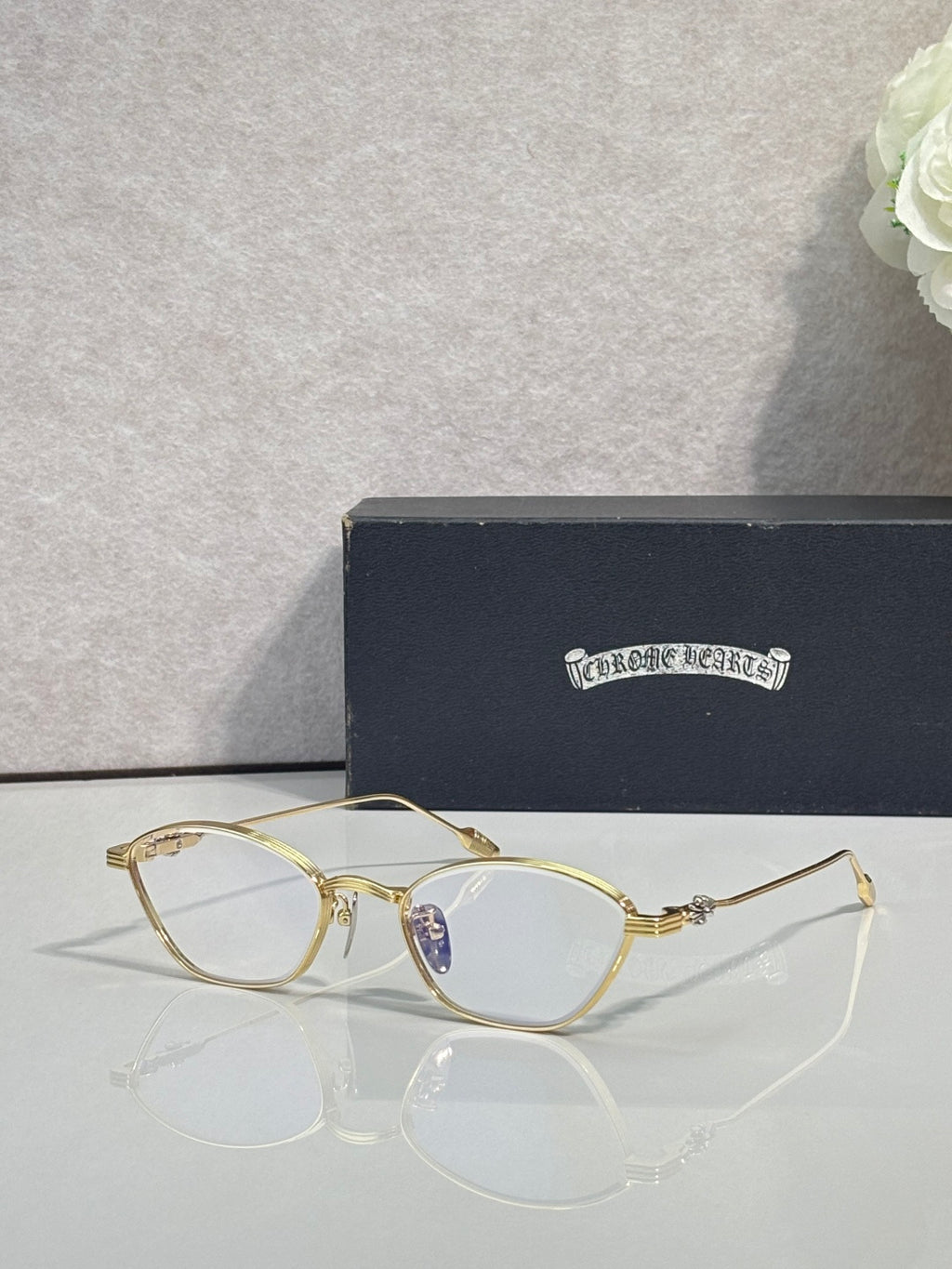 Gold metal frame eyeglasses with clear lenses and light purple tint round lenses