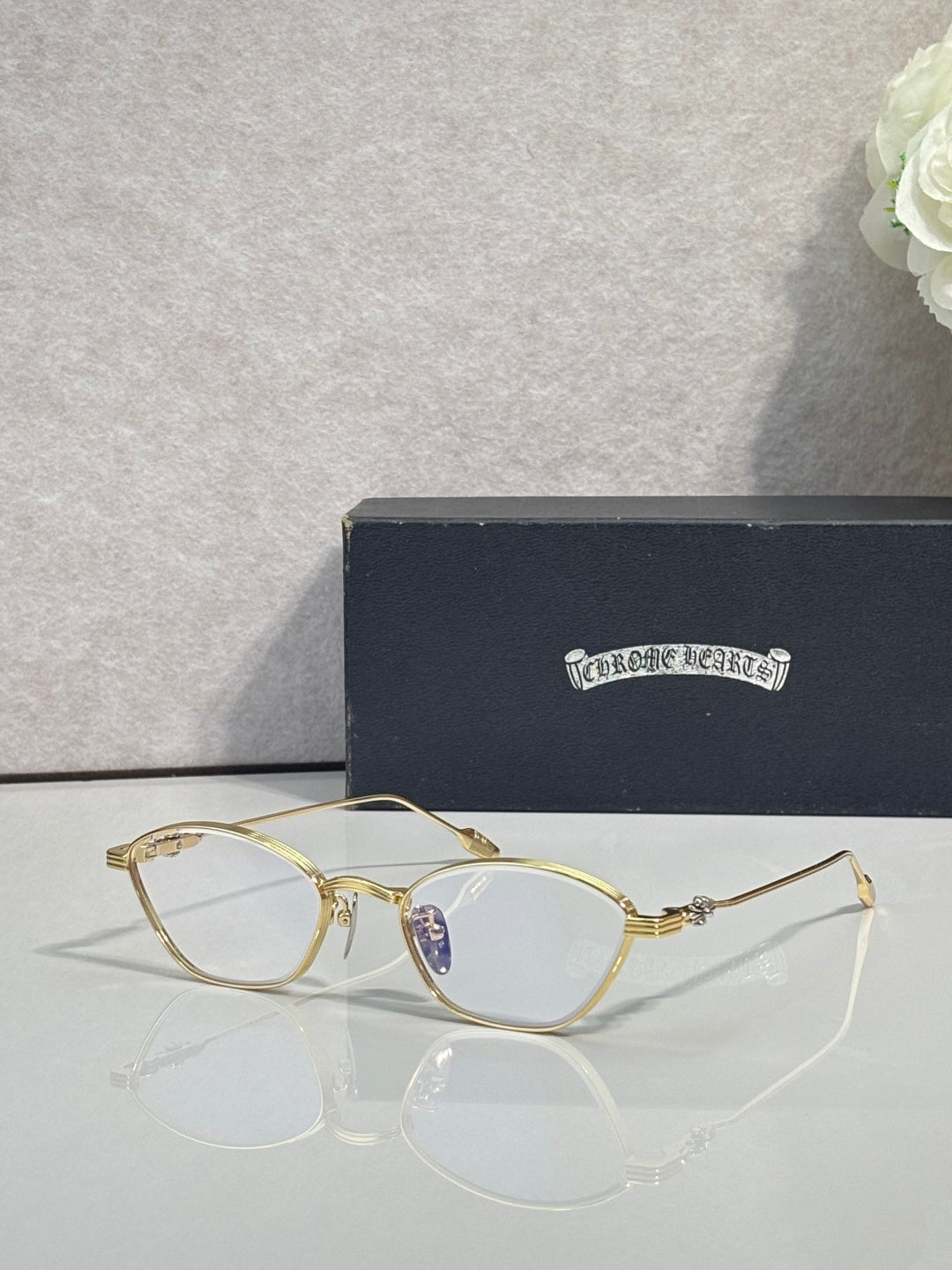 Gold metal frame eyeglasses with clear lenses and light purple tint round lenses