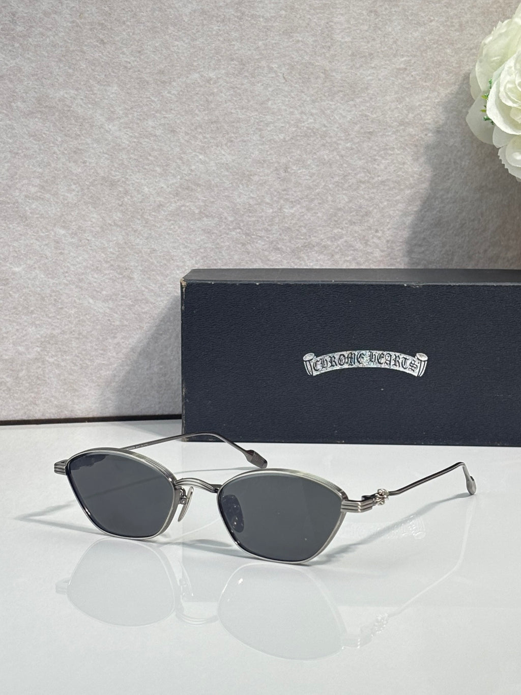 Silver metal frame sunglasses with dark gray round lenses and slim temples