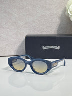 Navy round-frame glasses with tinted lenses and gold detail on temple