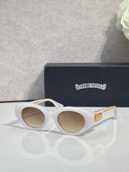 White round-frame glasses with tinted lenses and gold detail on temple