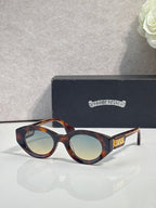 Tortoiseshell round-frame glasses with tinted lenses and gold detail on temple